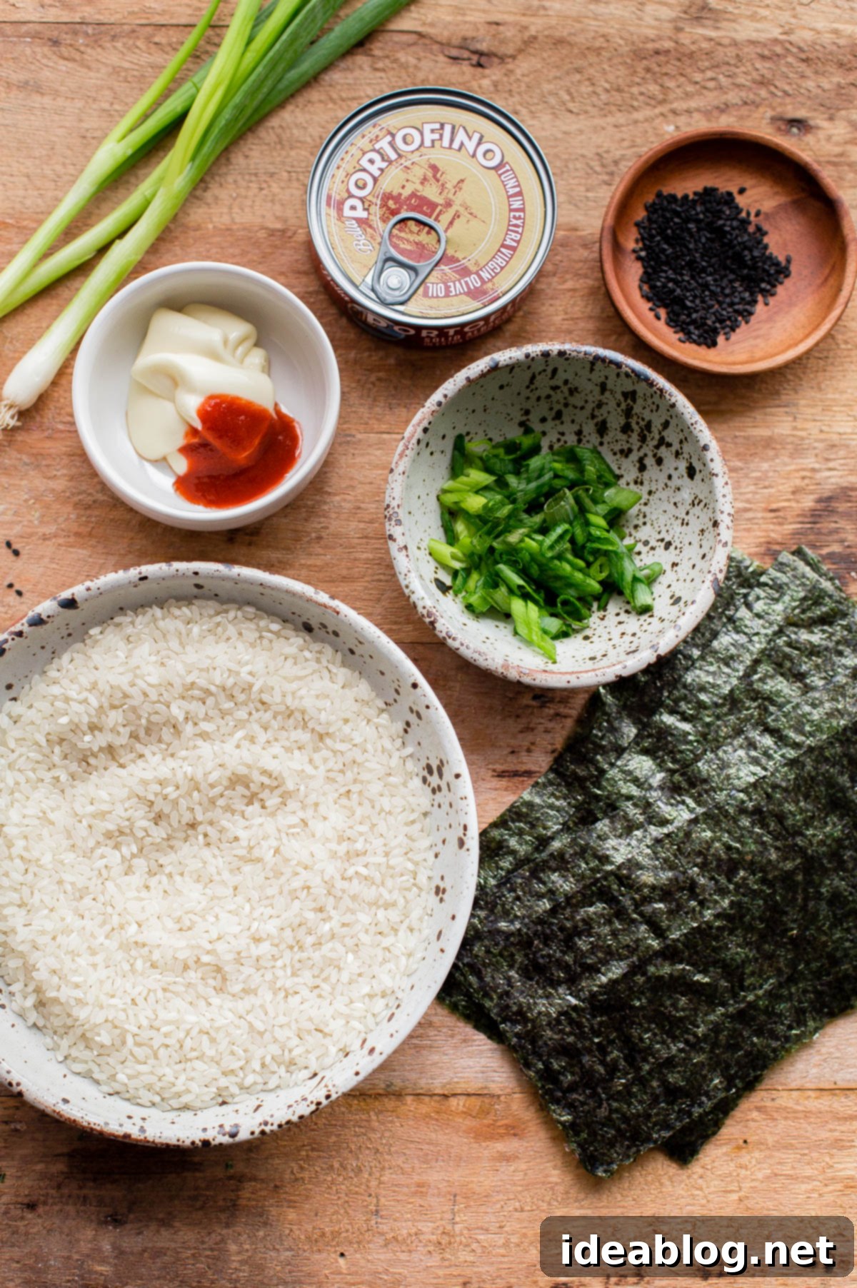 Homemade Spicy Tuna Onigiri - learn how to make homemade nigiri with this simple recipe! This spicy tuna onigiri version is filled with a simple filling of canned olive oil packed tuna, mayonnaise, sriracha, rice vinegar, and scallion. #onigiri #japanese #abeautifulplate #tuna #recipe #snack #glutenfree Ingredients for Homemade Tuna Onigiri: Japanese short-grain rice, canned olive oil packed tuna, mayonnaise, sriracha, rice vinegar, scallions, and nori.
