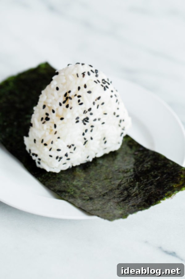 Spicy Tuna Onigiri 4 Freshly made homemade onigiri, ready to be filled and shaped, showcasing the soft, sticky rice texture.