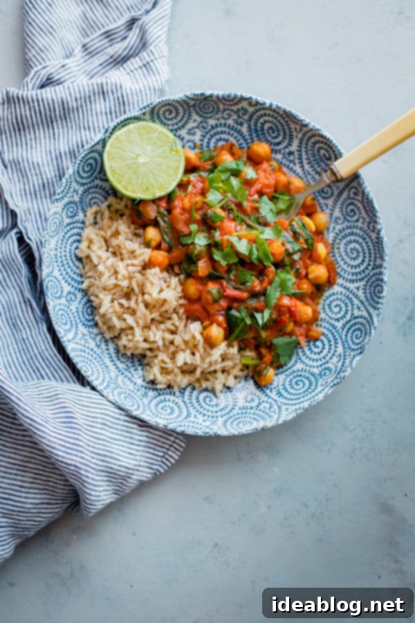 Everyday Chickpea Curry- this VEGETARIAN curry comes together in less than 30 minutes! #abeautifulplate #vegan #vegetarian #chickpea #curry #recipe #easydinner Easy Chickpea Curry with creamy coconut milk, fresh baby spinach, and bright cilantro.