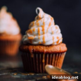 Fluffy Pumpkin Cloud Cupcakes 7 Pumpkin Cupcakes with Marshmallow Frosting and Caramel. This decadent fall cupcakes are lightly spiced and make a wonderful portable fall dessert.