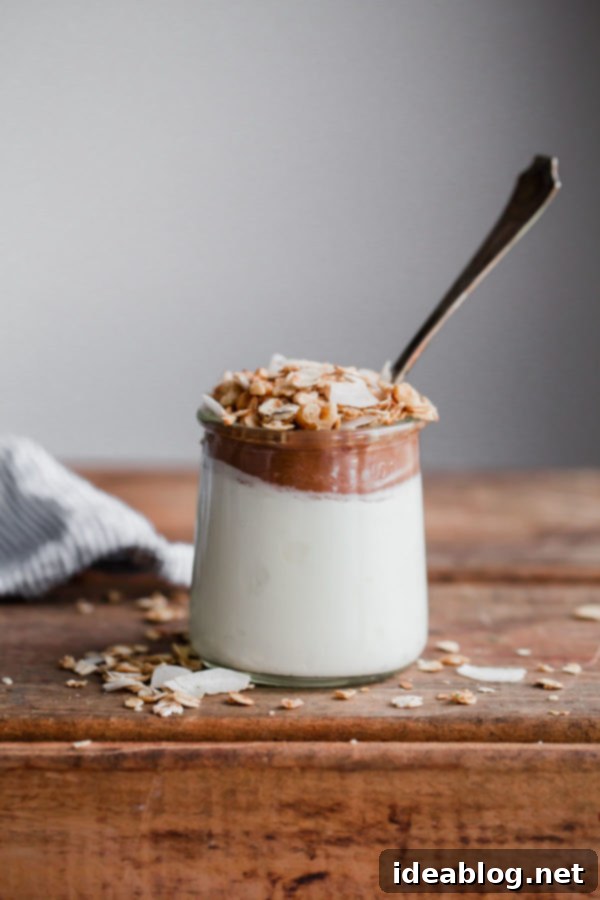 Instant Pot Apple Sauce - this EASY pressure cooker apple sauce recipe contains zero added sugar, requires zero peeling, and can be made in less than 30 minutes! Serve it with Greek yogurt and granola for a healthy breakfast. #instantpot #applesauce #apple #fallfood #comfortfood Bowl of Instant Pot Applesauce with a spoon and fall decor