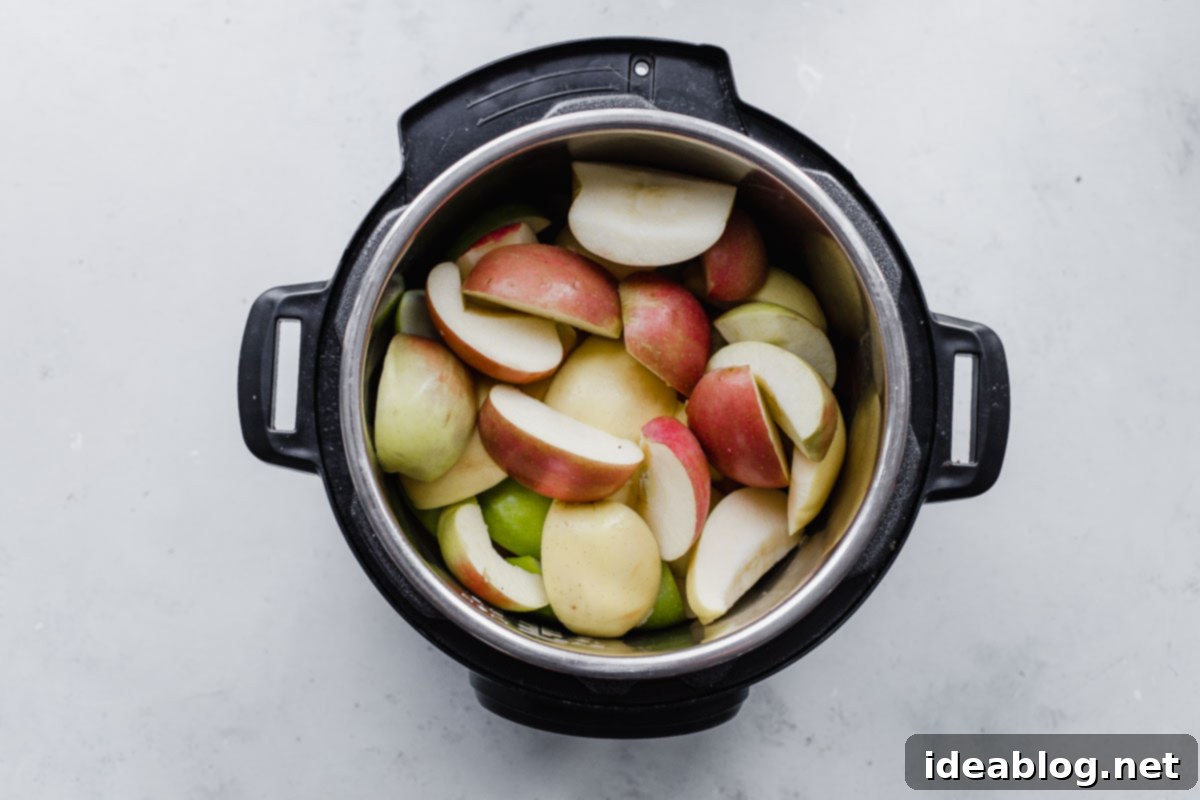Homemade Instant Pot Applesauce 4 Apples and spices in an Instant Pot before cooking