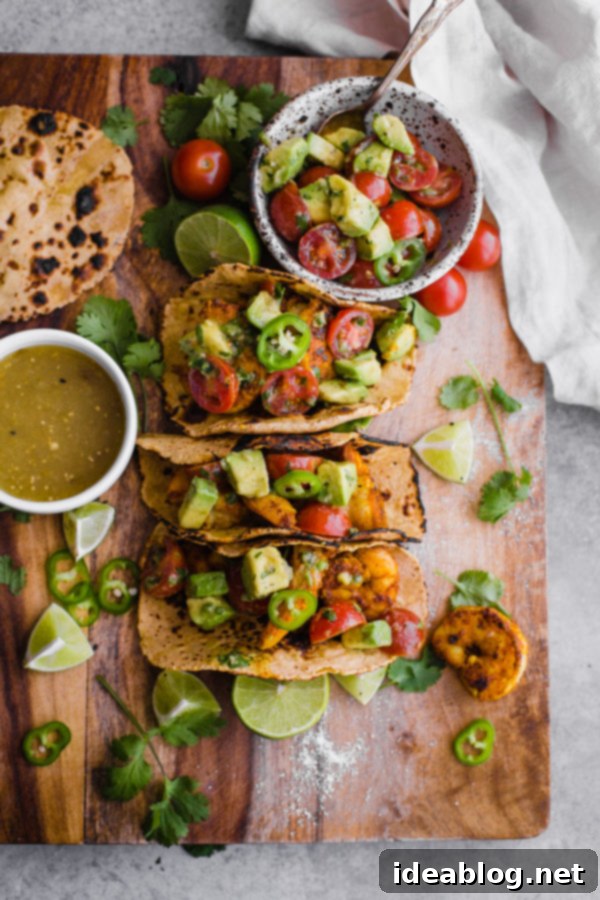 Mumbai Shrimp Tacos with Avocado Salsa - this EASY shrimp taco recipe is packed with spice and topped with a simple avocado tomato salsa! 