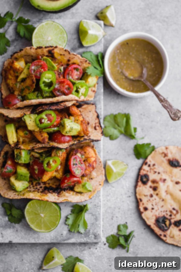 Mumbai Shrimp Tacos with Avocado Salsa - this EASY shrimp taco recipe is packed with spice and topped with a simple avocado tomato salsa!