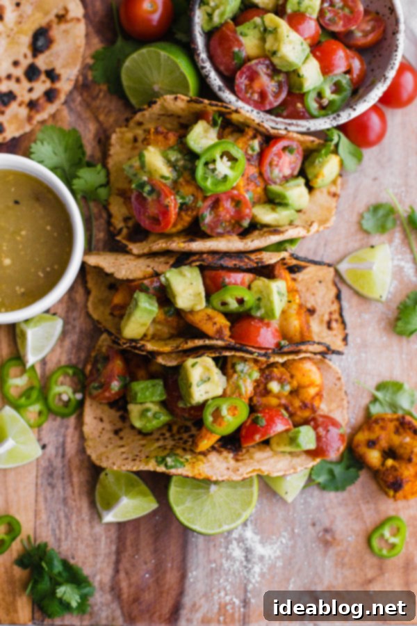 Mumbai Shrimp Tacos with Avocado Salsa - this EASY shrimp taco recipe is packed with spice and topped with a simple avocado tomato salsa!