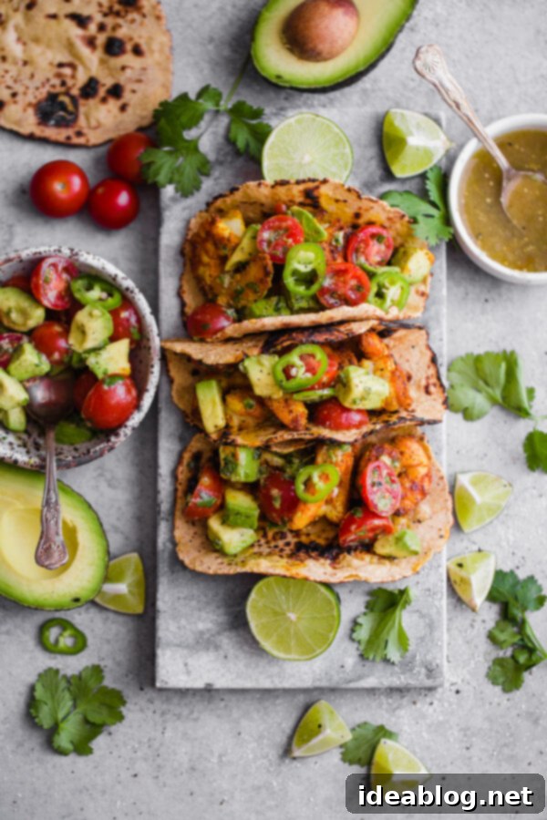 Mumbai Shrimp Tacos with Avocado Salsa - this EASY shrimp taco recipe is packed with spice and topped with a simple avocado tomato salsa!