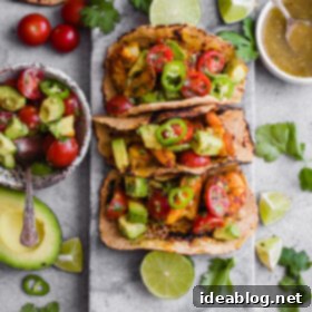 Mumbai Shrimp Tacos with Avocado Salsa - this EASY shrimp taco recipe is packed with spice and topped with a simple avocado tomato salsa!