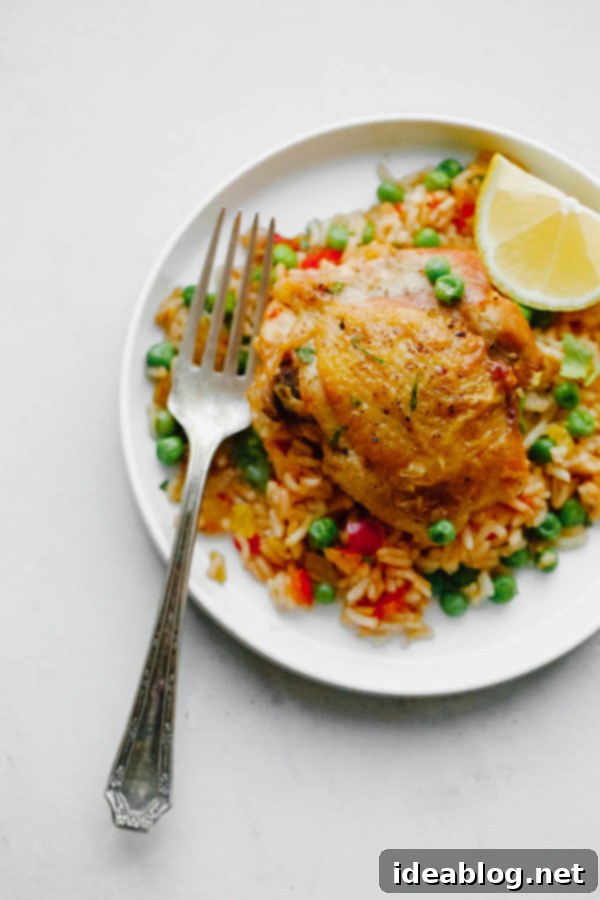 Savory Chicken & Rice Harmony 3 Arroz Con Pollo simmering in a pan, showcasing the rich colors and textures.