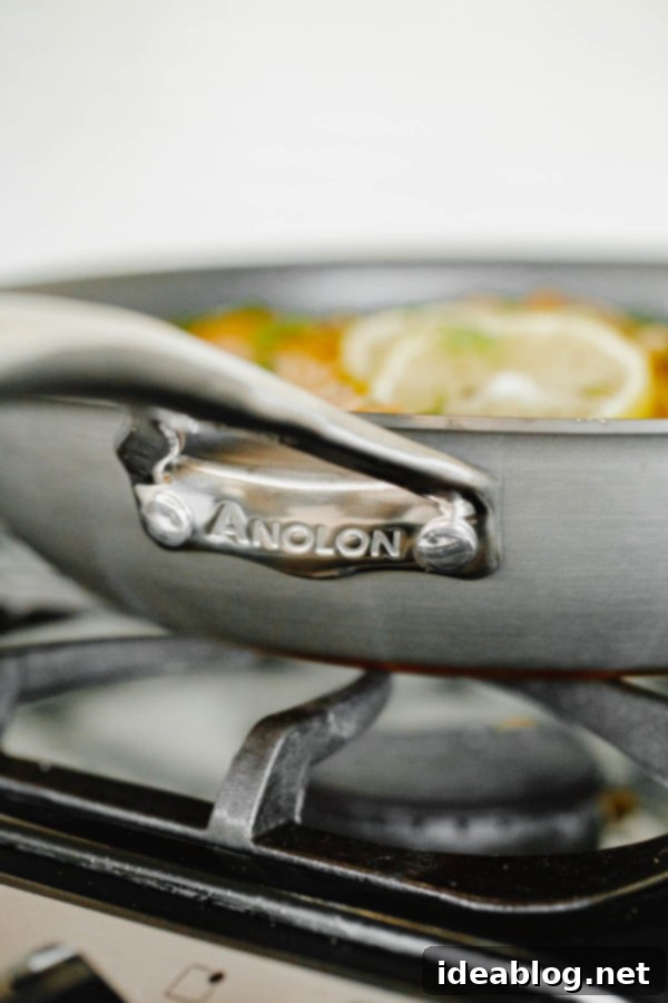 Savory Chicken & Rice Harmony 5 Arroz Con Pollo cooking in the Anolon Nouvelle Copper skillet, covered with a domed lid.