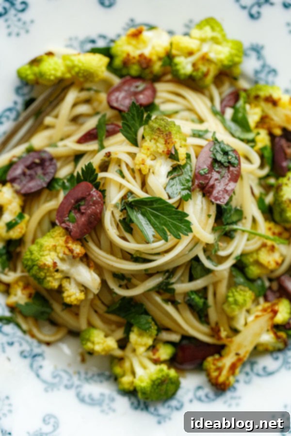 Romanesco Cauliflower Pasta with Olives, Capers, and Parsley. A simple vegetarian pasta recipe that can be made in less than 45 minutes, a perfect healthy weeknight meal. #pasta #recipe #romanesco #cauliflower #olive #caper #abeautifulplate Romanesco Cauliflower Pasta with Olives, Capers, and Parsley, freshly tossed and ready to serve.