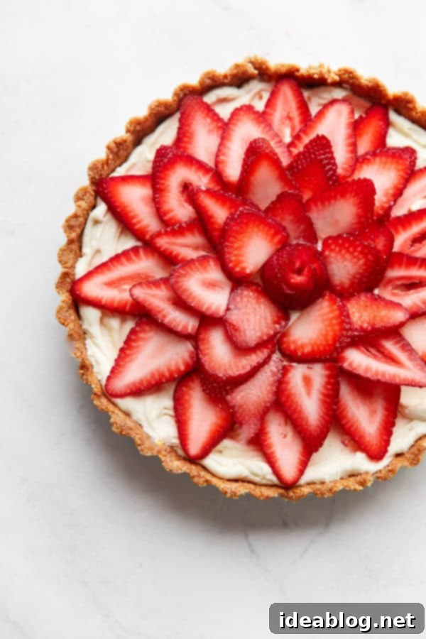 Luscious Strawberry Mascarpone Tart 6 Strawberry Tart being garnished with almonds and mint