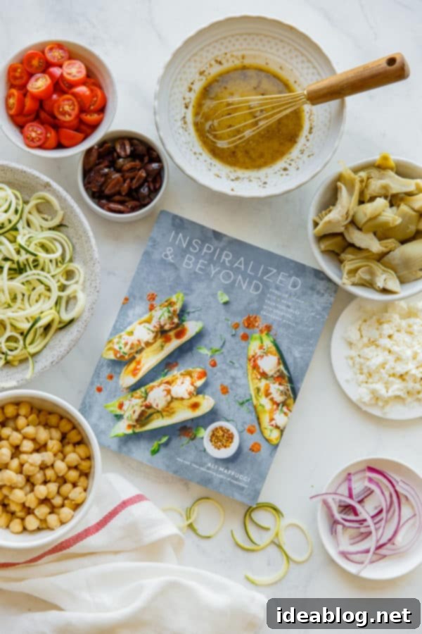 Mediterranean Zucchini Pasta Salad - this refreshing and lightened up Mediterranean Zucchini Pasta Salad is prepared with zucchini noodles in lieu of traditional pasta, and tossed with briny feta, chickpeas, artichoke hearts, tomatoes, spinach, and olives. #zucchini #vegetarian #glutenfree #abeautifulplate #healthy #Mediterranean Inspiralized and Beyond Cookbook