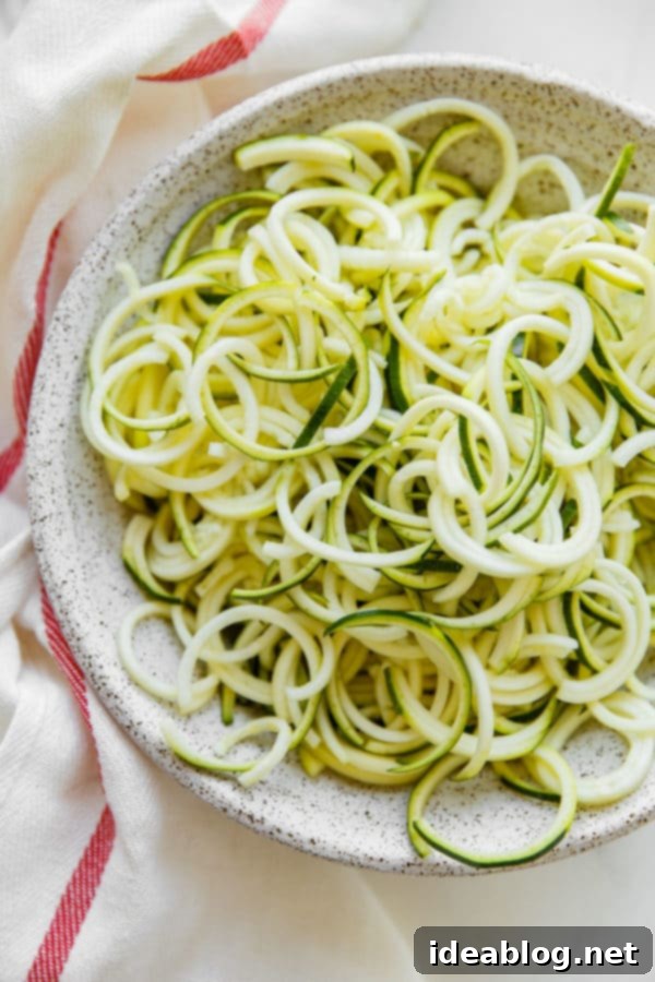 Mediterranean Zucchini Pasta Salad - this refreshing and lightened up Mediterranean Zucchini Pasta Salad is prepared with zucchini noodles in lieu of traditional pasta, and tossed with briny feta, chickpeas, artichoke hearts, tomatoes, spinach, and olives. #zucchini #vegetarian #glutenfree #abeautifulplate #healthy #Mediterranean Zucchini Noodles