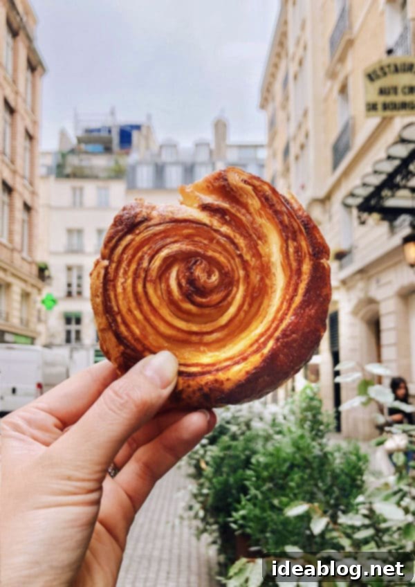The Taste of Paris: Your Dining Companion 12 A perfectly flaky Kouign-Amann from Stohrer, a highlight of Parisian pastries.