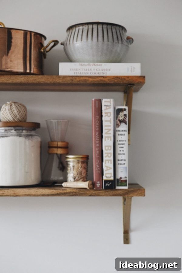 A Complete Guide to Making Homemade Sourdough Bread at Home: Essential tools and resources for incredible sourdough results – an extensive and detailed guide to my favorite sourdough bread tools and resources. A beautifully organized kitchen shelf displaying various sourdough baking tools