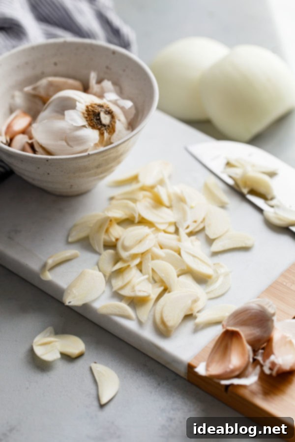 Zesty Burmese Chicken Salad 2 Thinly sliced garlic cloves prepared for frying, ready to become crispy garlic chips.