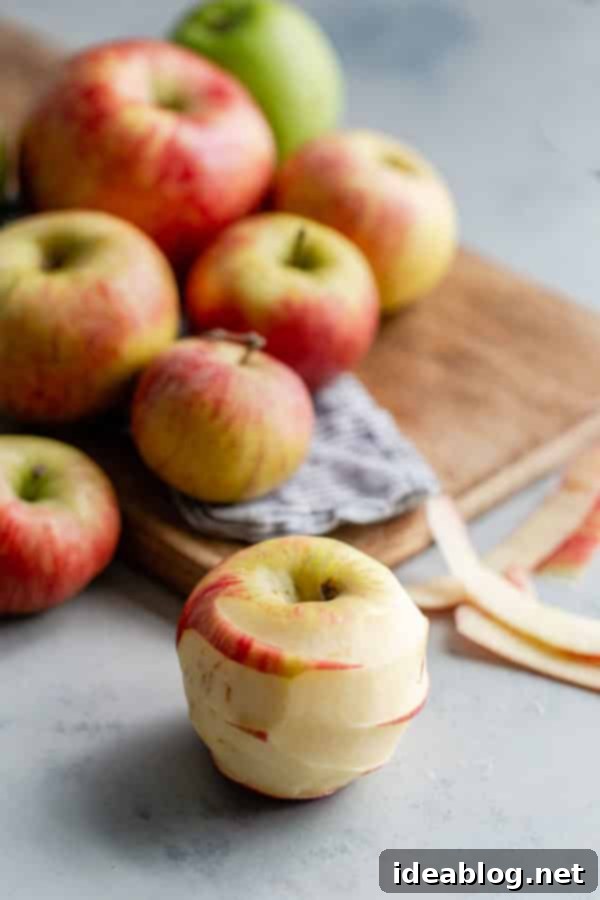 Apple Hazelnut Crisp - this DELICIOUS apple crisp recipe is the perfect mix of sweet and tart, and topped with a buttery hazelnut oat crisp topping. Fresh Honeycrisp apples on cutting board