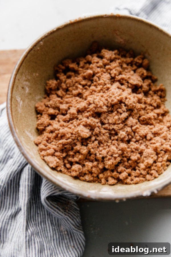 Harvest Spice Coffee Cake with Creamy Pumpkin Swirl 7 Close-up of the prepared coffee cake streusel topping, showing its rich, crumbly texture, ready for baking.