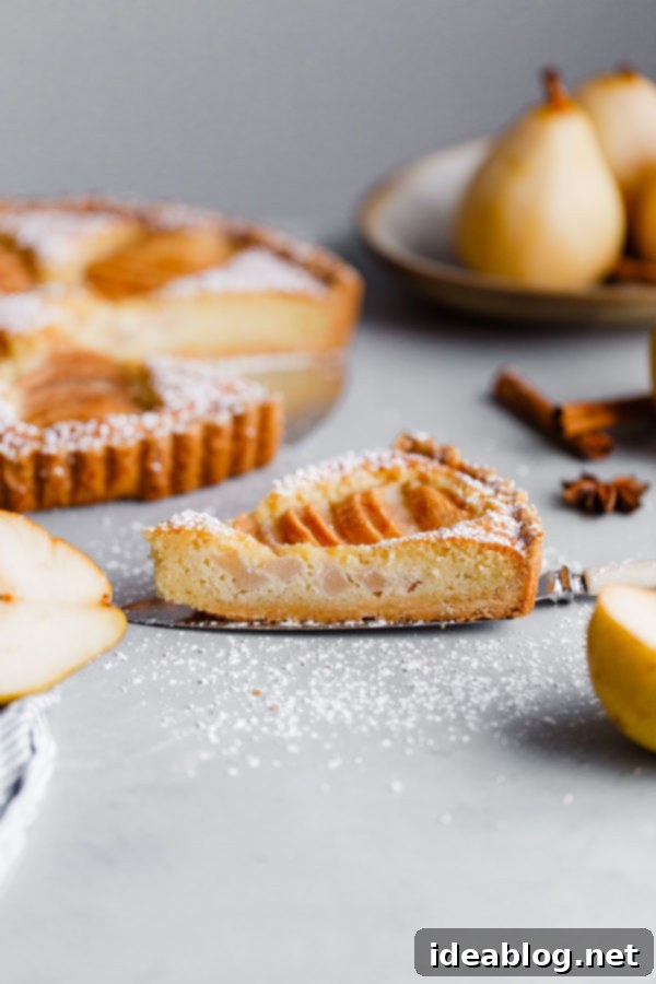 Elegant Pear & Almond Tart 9 Close-up of the delicate fluted edge of a perfectly blind-baked tart crust, showcasing the golden hue and sturdy structure ready to hold the frangipane and poached pear filling
