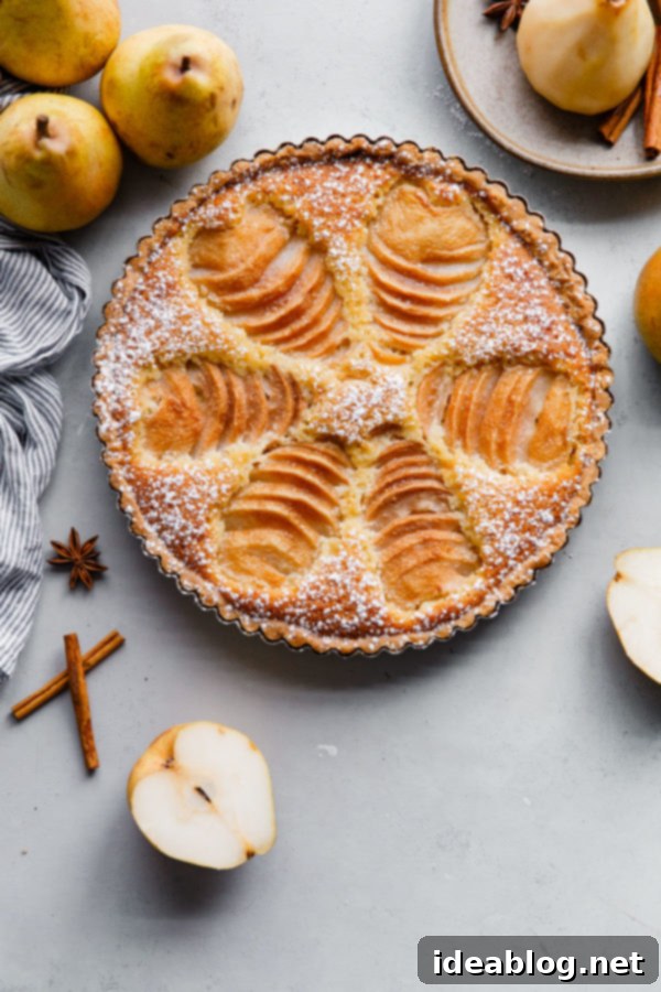 Elegant Pear & Almond Tart 5 Close-up of the rustic texture of a baked Pear Frangipane Tart, highlighting the golden brown crust and the inviting aroma of almonds and pears