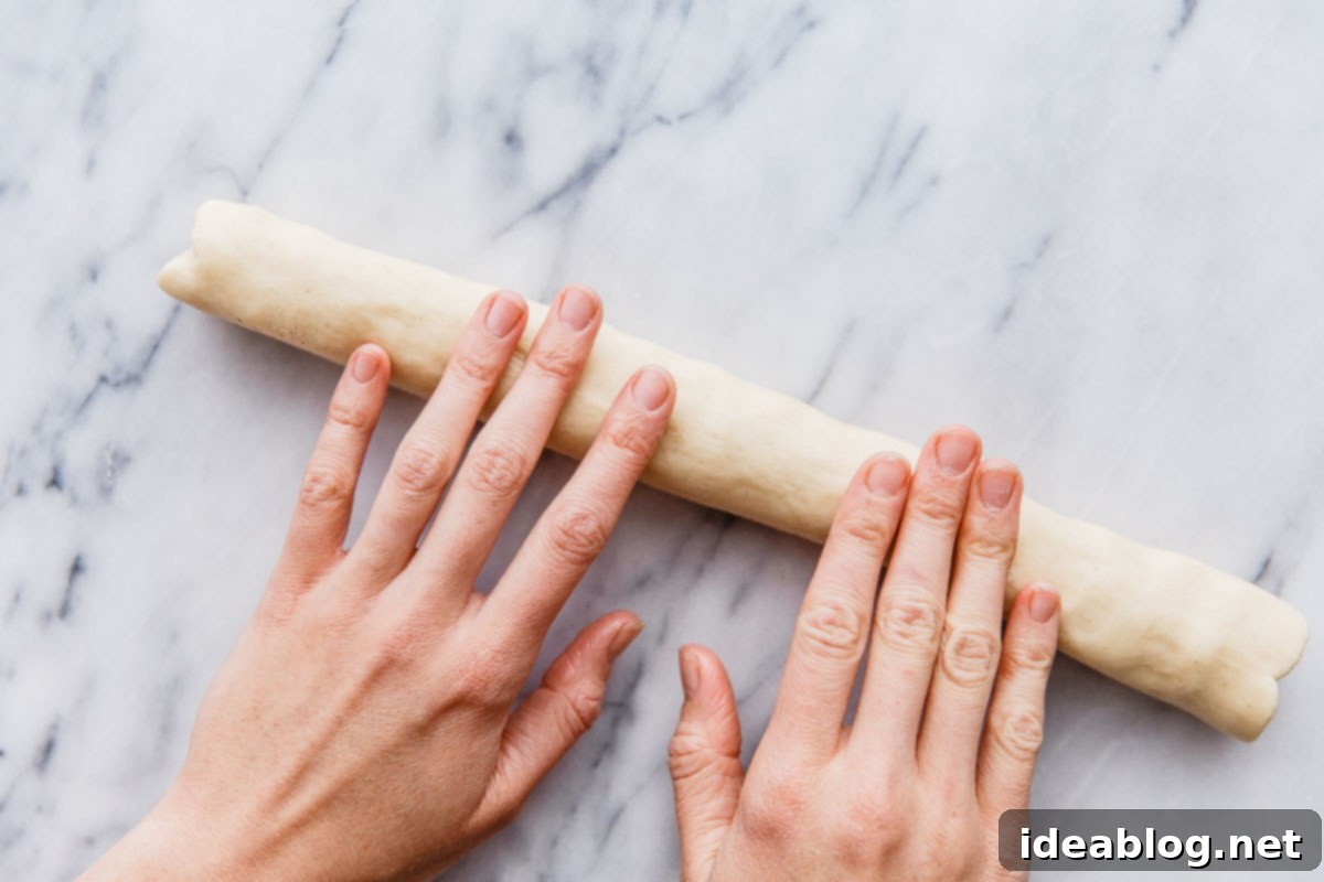 Buttery Almond Moons 12 Rolling half of the cookie dough into a log shape.
