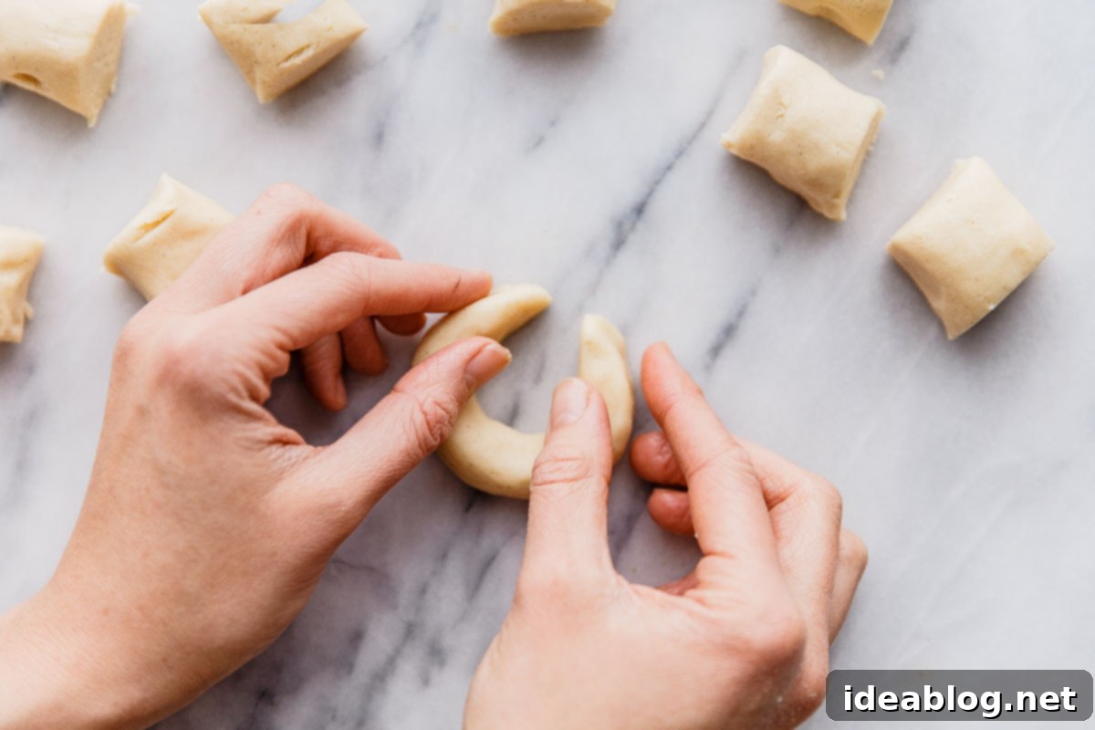 Buttery Almond Moons 14 Shaping small dough logs into crescent moons.