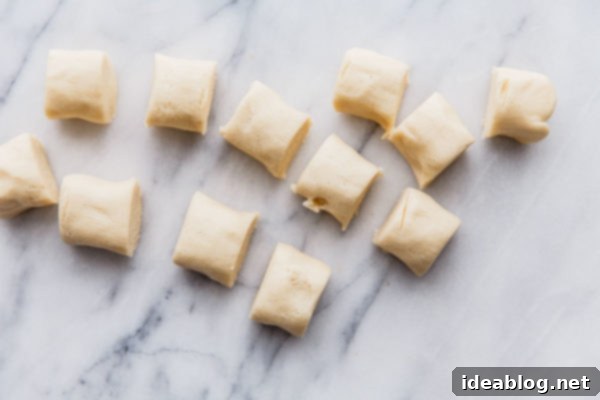 Buttery Almond Moons 6 Portioned cookie dough pieces before rolling into longer logs.