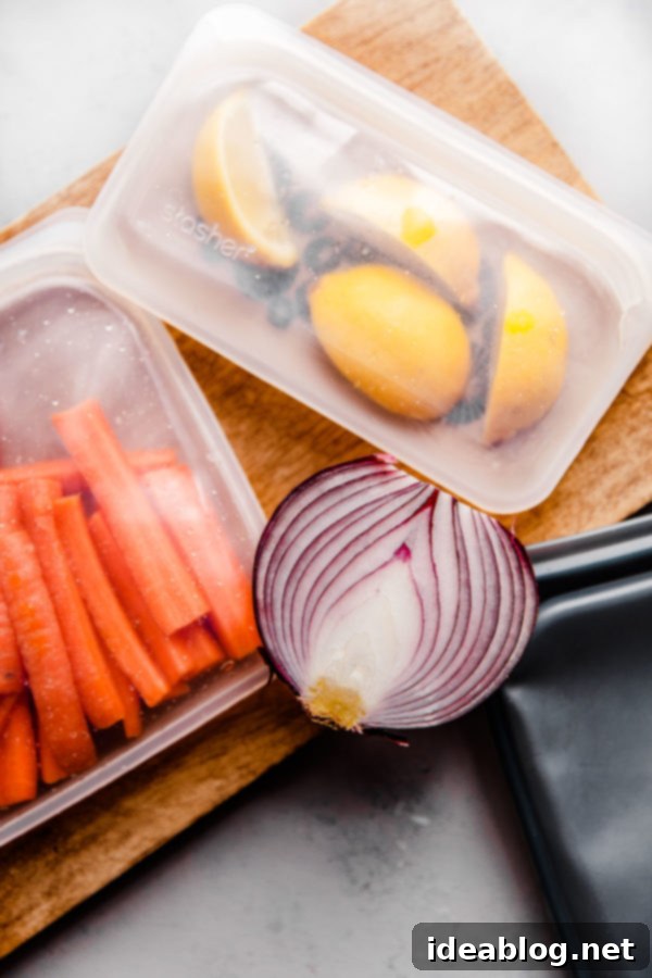 5 Easy Ways to Reduce Kitchen Waste - helpful resources, practical tools and tips, and approachable ways to reduce your kitchen waste and carbon footprint.  Various foods stored in reusable silicone Stasher bags, showcasing sustainable food storage.