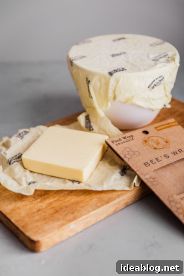 5 Easy Ways to Reduce Kitchen Waste - helpful resources, practical tools and tips, and approachable ways to reduce your kitchen waste and carbon footprint.  Bowls and food items wrapped in Bee's Wrap, a natural alternative to plastic wrap.