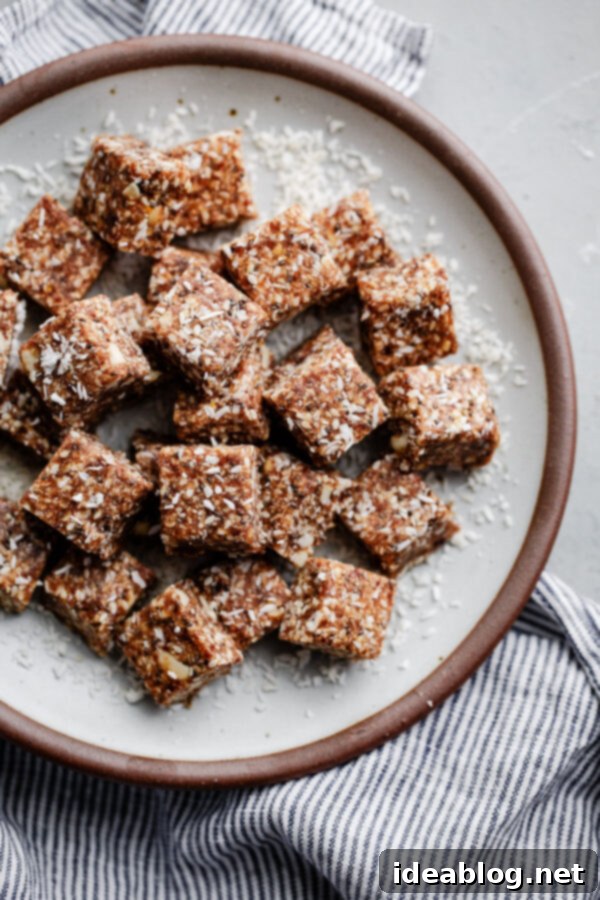 Coconut Cashew Chia Energy Bites - a super satisfying, naturally sweetened snack packed with dates, cashews, coconut, chia, sesame, and orange zest. Gluten-free, paleo, and vegan friendly. Delicious No-Bake Coconut Cashew Chia Energy Bites on a plate, ready to be enjoyed as a healthy snack or pre-workout fuel.