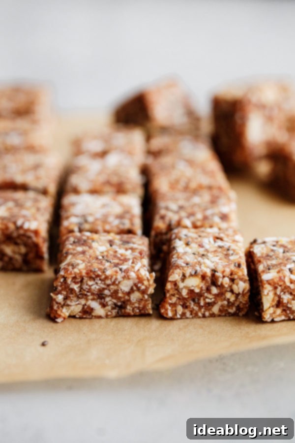 Coconut Cashew Chia Energy Bites - a super satisfying, naturally sweetened snack packed with dates, cashews, coconut, chia, sesame, and orange zest. Gluten-free, paleo, and vegan friendly. A neatly arranged platter of sliced Coconut Cashew Chia Energy Bites, showcasing their even square shape and enticing textures.