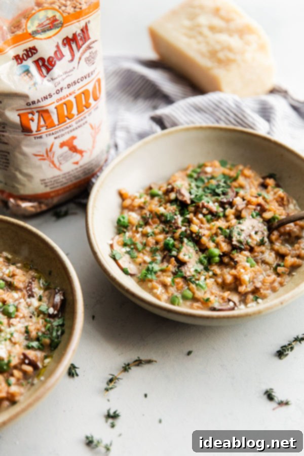 Healthy Mushroom Farro Risotto – featuring Bob's Red Mill Farro for an easy, no-stir, creamy dinner. A bowl of Mushroom Farro Risotto with thawed peas, accompanied by a bag of Bob's Red Mill Organic Farro in the background, highlighting the key ingredient.