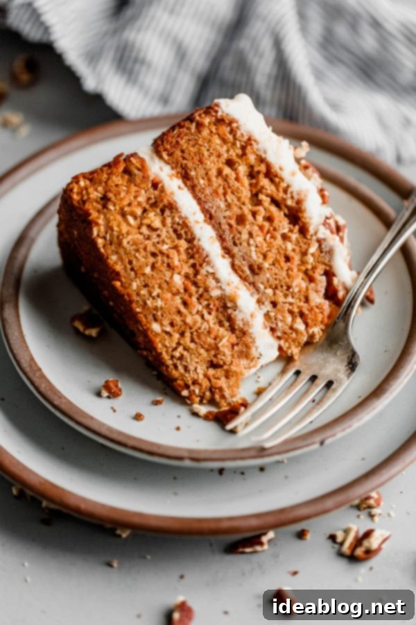 Indulgent Slice of Carrot Cake with Pineapple, Coconut, and Zesty Lemon Frosting Close-up of a Slice of Moist Carrot Cake with a Bite Taken Out