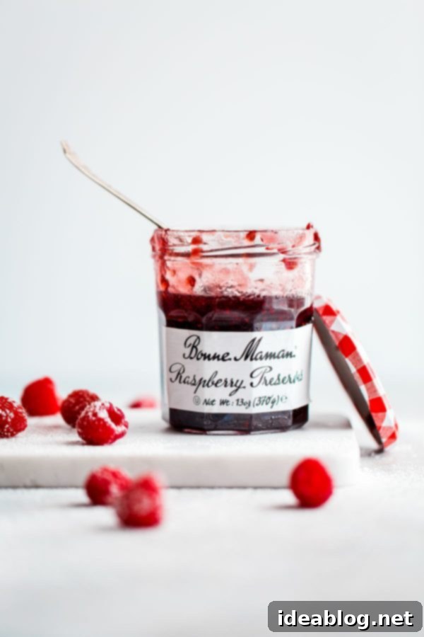 Vibrant Raspberry Matcha Roll Cake 2 Bonne Maman Raspberry Preserves jar, perfect for baking