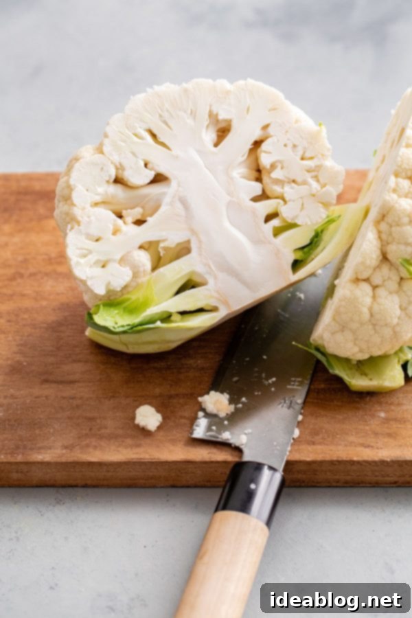 How to Cut Cauliflower - a simple step by step guide on how to cut cauliflower (and how to cut cauliflower florets) for your favorite cauliflower recipes. #abeautifulplate #cooking #guide #cauliflower #howto Sliced Head of Cauliflower Ready for Florets