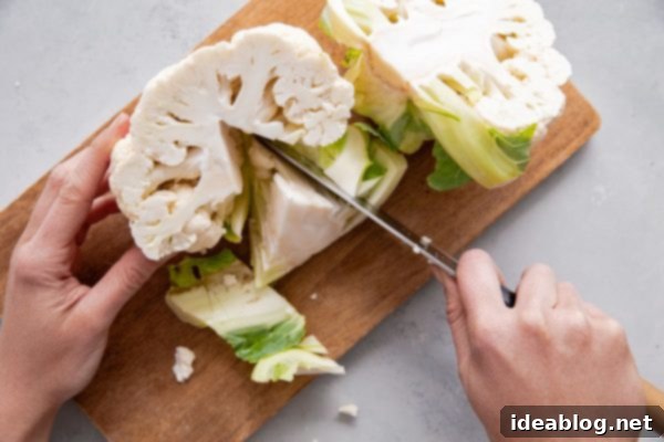 How to Cut Cauliflower - a simple step by step guide on how to cut cauliflower (and how to cut cauliflower florets) for your favorite cauliflower recipes. #abeautifulplate #cooking #guide #cauliflower #howto Cauliflower Halved for Core Removal