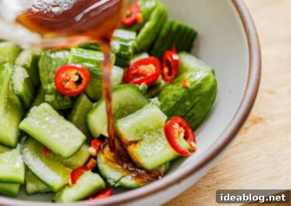Garlic Chili Smashed Cucumber Salad 6 Smashed cucumbers salted and resting in a bowl