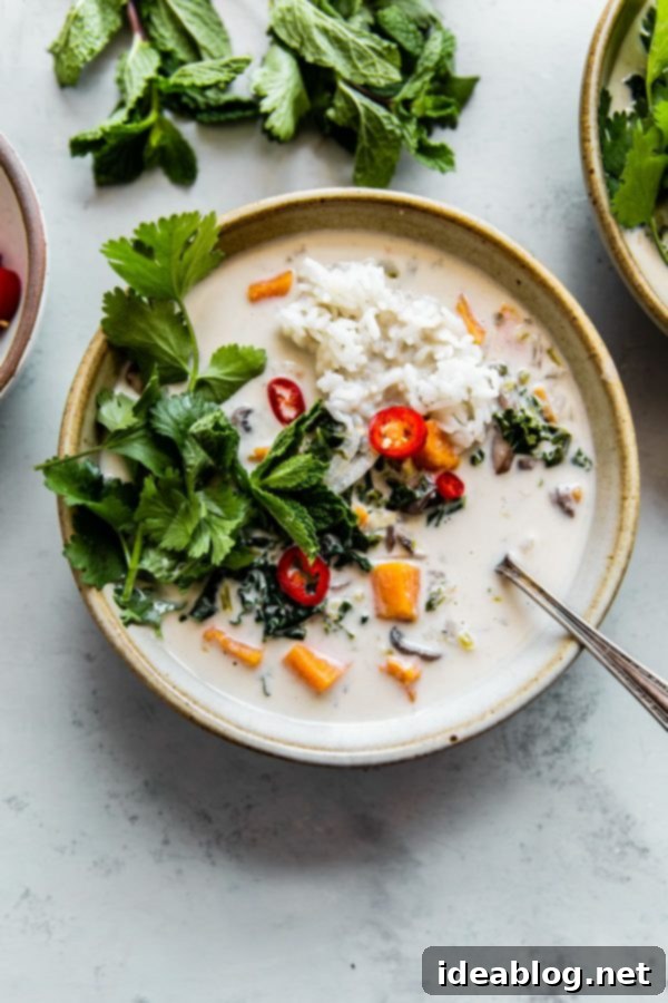 Vegetarian Thai Coconut Soup (Easy Tom Kha Gai) - a delicious, fragrant, vegan Thai coconut soup prepared with sweet potato and kale. #coconutsoup #tomkhagai #thai #recipe #soup #vegan #glutenfree #dairyfree #vegetarian #abeautifulplate #recipe  Vegetarian Thai Coconut Soup