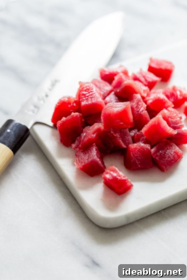 High-Quality Raw Diced Tuna for Traditional Shoyu Ahi Poke Recipe Raw diced sashimi-grade tuna cubes, prepared for poke