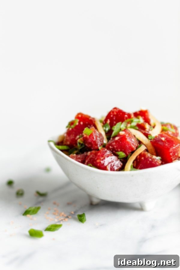 Delicious Shoyu Ahi Poke Bowl with fresh tuna, macadamia nuts, and scallions Prepared Shoyu Ahi Poke with fresh ingredients in a serving bowl