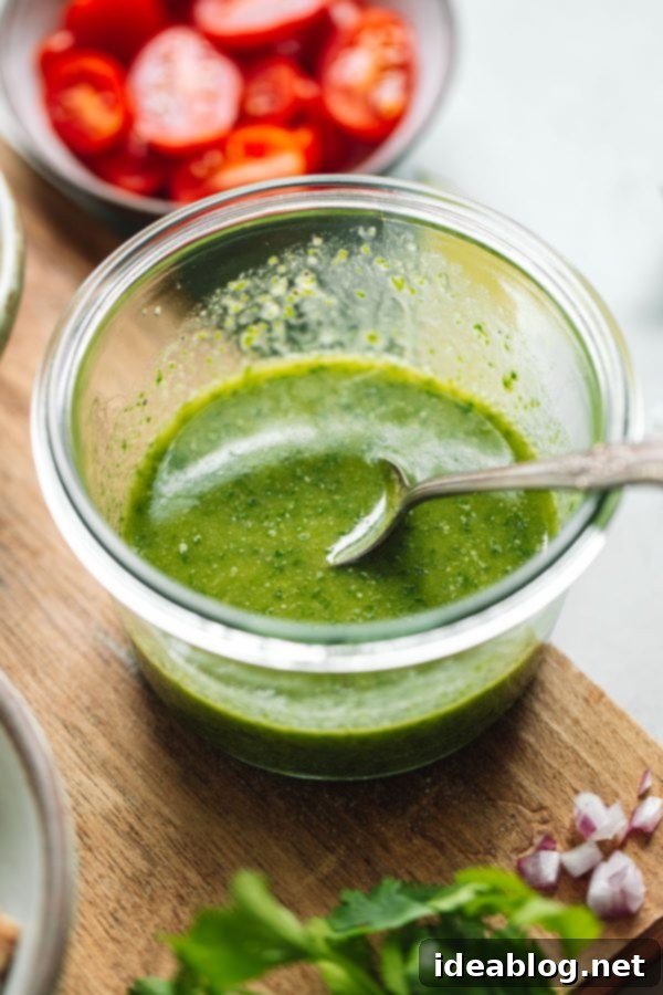 Cilantro Lime Vinaigrette - this bright herb vinaigrette, infused with fresh jalapeño, is delicious tossed with salads, grain bowls, and other dishes! #cilantro #lime #vinaigrette #abeautifulplate Cilantro Lime Vinaigrette