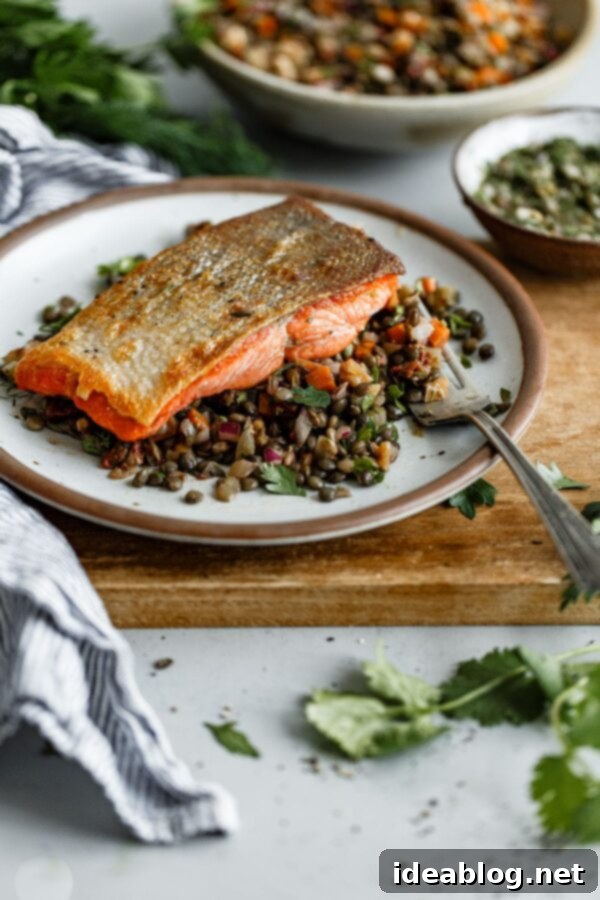 Pan Seared Salmon with French Lentil Salad - crispy pan seared salmon topped with a zesty caper herb vinaigrette and served alongside a flavorful French lentil salad. #sponsored #salmon #lentils #abeautifulplate #recipe #healthy #dinner #glutenfree #dairyfree Pan Seared Salmon with French Lentil Salad - A delicious and healthy main course featuring crispy salmon, zesty vinaigrette, and a hearty French lentil salad. Perfect for healthy weeknight dinners. #salmon #lentils #recipe #healthy #dinner