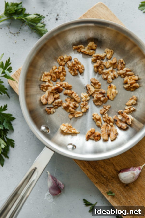 Toasted Walnuts in a Skillet - golden brown and fragrant, ready for the lentil salad.