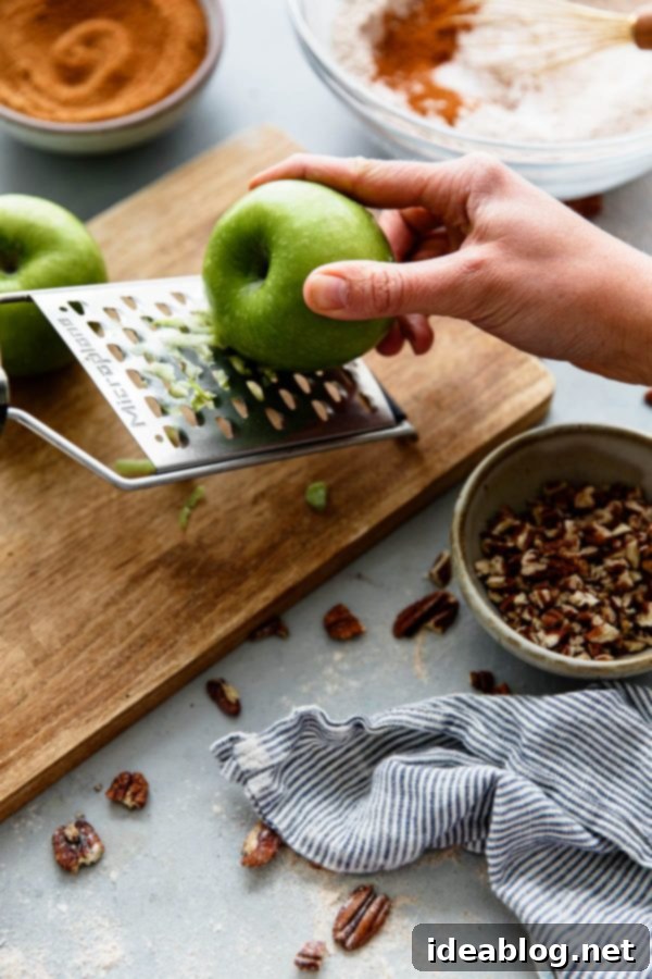 Wholesome Apple Cinnamon Muffins 3 How to Make Apple Cinnamon Muffins - adding grated apples to the batter.