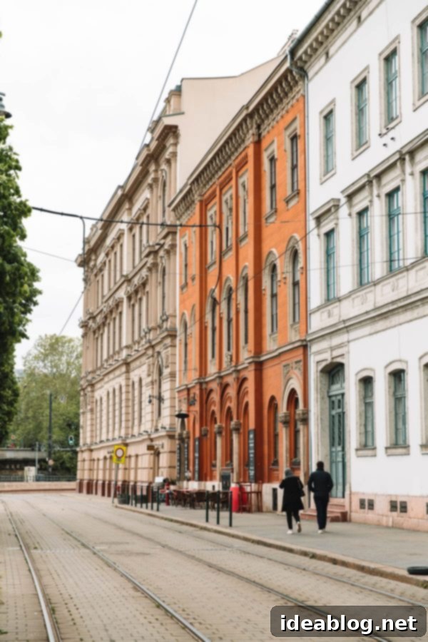 Budapest Travel Guide - with recommendations on must-visit destinations, where to stay, and where to eat in the region. #travel #budapest #travelguide Cobblestone street in Budapest with colorful buildings