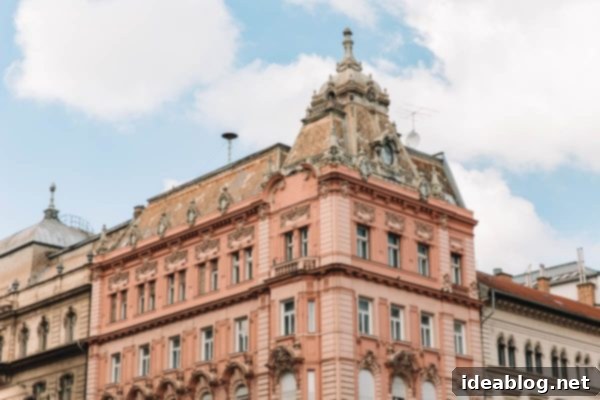 Budapest Travel Guide - with recommendations on must-visit destinations, where to stay, and where to eat in the region. #travel #budapest #travelguide Historic buildings lining a street in Budapest