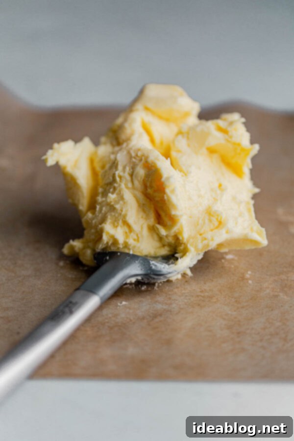 Freshly Prepared Homemade Cultured Butter - Ready for Flavoring and Storage Perfectly washed and prepared homemade cultured butter on a cutting board, ready for shaping and optional seasoning.