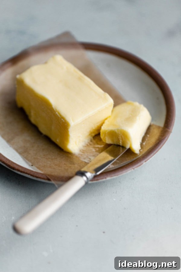 The Art of Cultured Butter 3 High-quality heavy cream in a bowl with a culturing agent being added, initiating the fermentation process for homemade cultured butter.