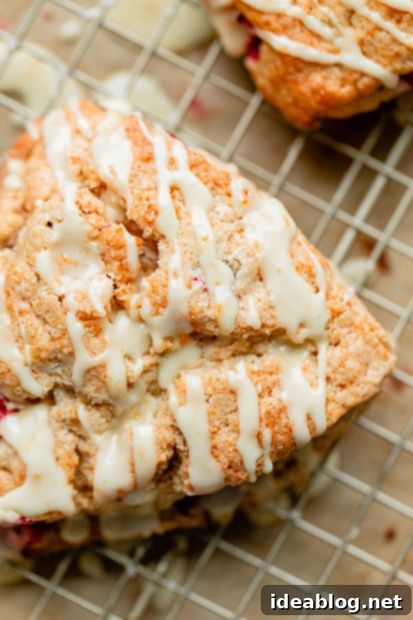 Sunrise Cranberry Orange Scones 9 A perfectly glazed Cranberry Orange Scone ready to be served, showcasing its vibrant flavors.