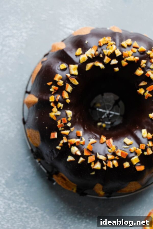 Orange Bundt Cake with Chocolate Glaze - The ultimate dessert for sharing, easy to make and beautifully presented. Chocolate Glaze Bundt Cake with Candied Orange - A stunning orange bundt cake covered in chocolate glaze, garnished with candied orange.